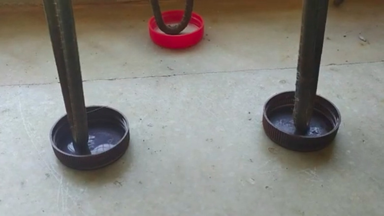Plastic jar lids used as scratch-preventing furniture leg caps