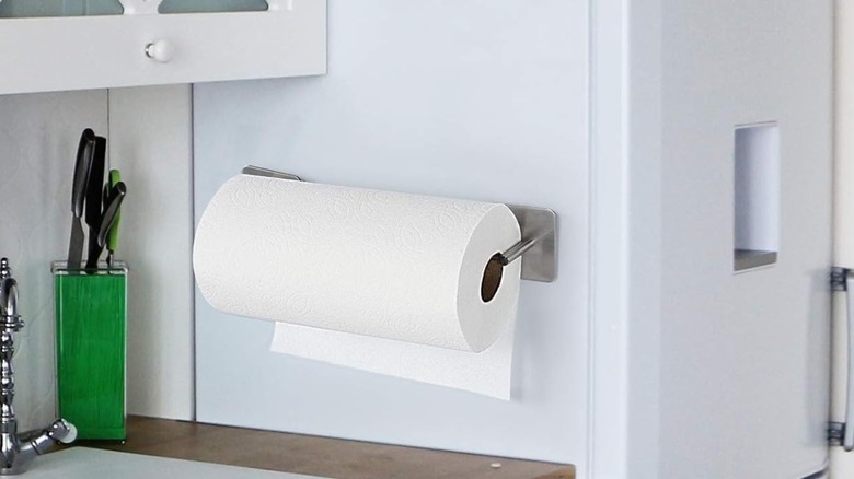 A magnetic two-piece paper towel holder attached to side of fridge