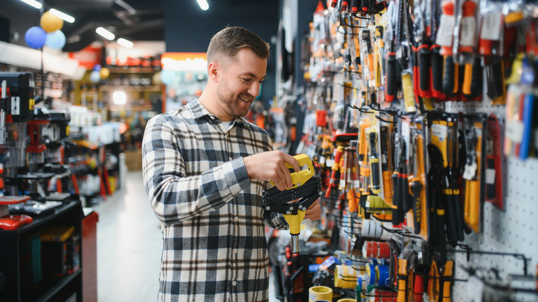 A man looking at tools in a hardware store