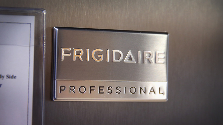 A Frigidaire logo on a brushed steel refrigerator
