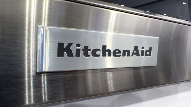 A KitchenAid logo on a stainless steel appliance