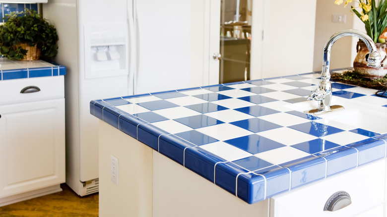 blue and white tiled counter with white grout in kitchen