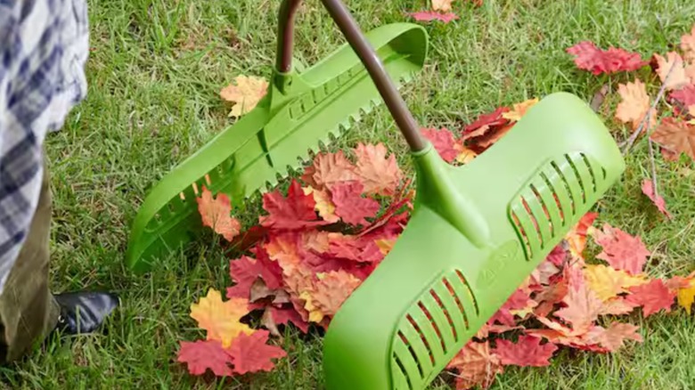 Person using the Ames Long Handle Leaf Collecting Tool.