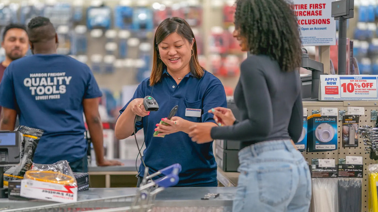 Friendly employees helping customers in a Harbor Freight store