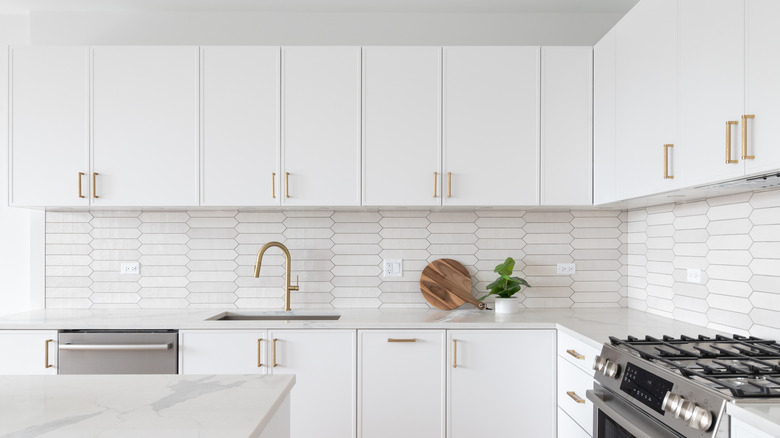 Kitchen with white cabinets and backsplash.