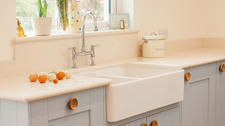 A modern farmhouse kitchen sink with Shaker cabinets
