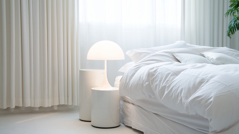 White bedding in a white room with white furniture