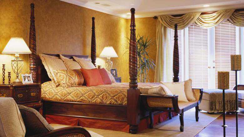 A dark wood four-poster bed