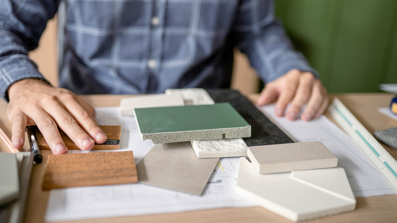Interior designer comparing backsplash tiles
