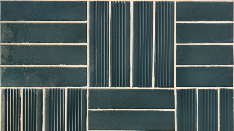 dark blue-green subway tile in a basketweave pattern