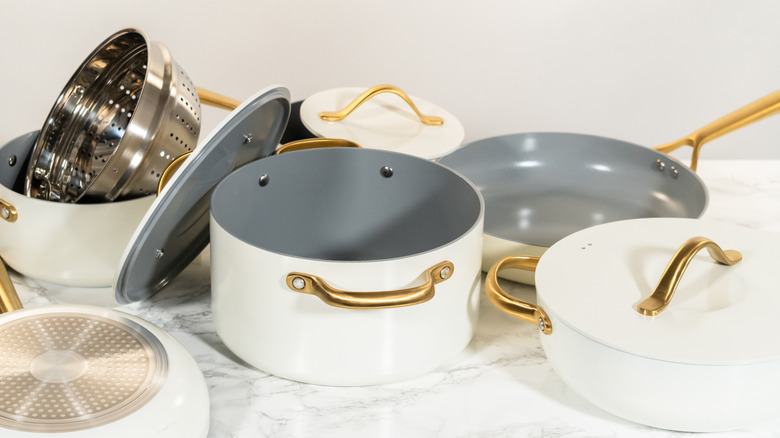 A collection of white ceramic cookware, including lids