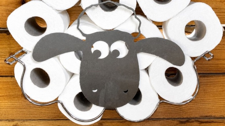 Repurposed wine rack used for toilet paper storage