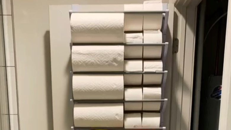 Shoe rack filled with paper towels and toilet paper