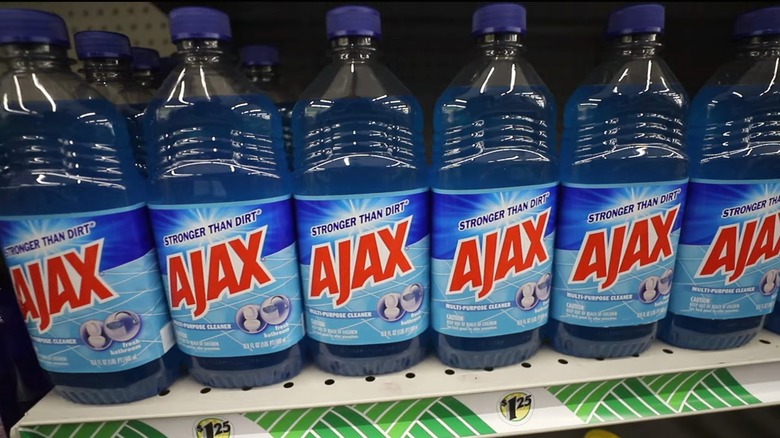 Bottles of Ajax Multipurpose Cleaner sit on a shelf at Dollar Tree