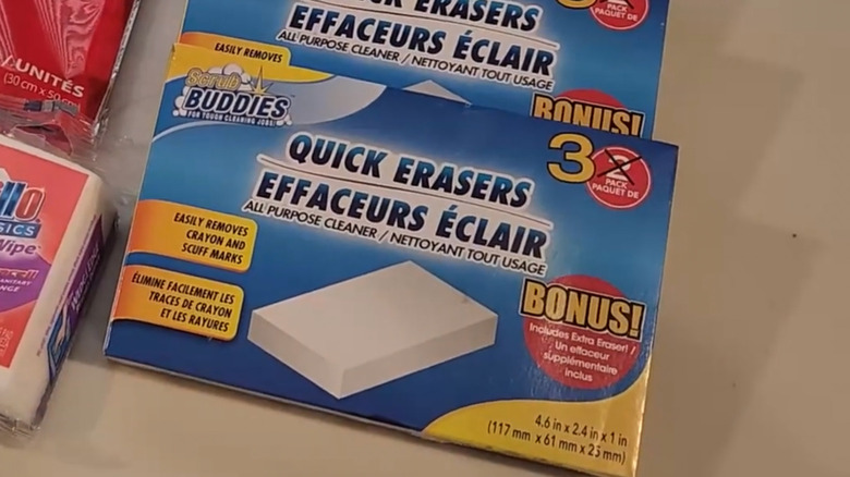 A box of Dollar Tree Scrub Buddies Quick Erasers sits on a white table