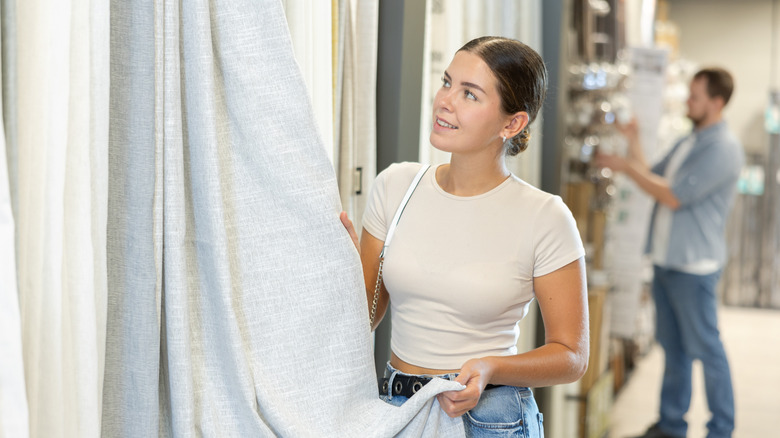 Woman shopping for curtains at a store