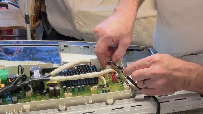 Disconnecting the lid lock from the controller board on an LG washing machine
