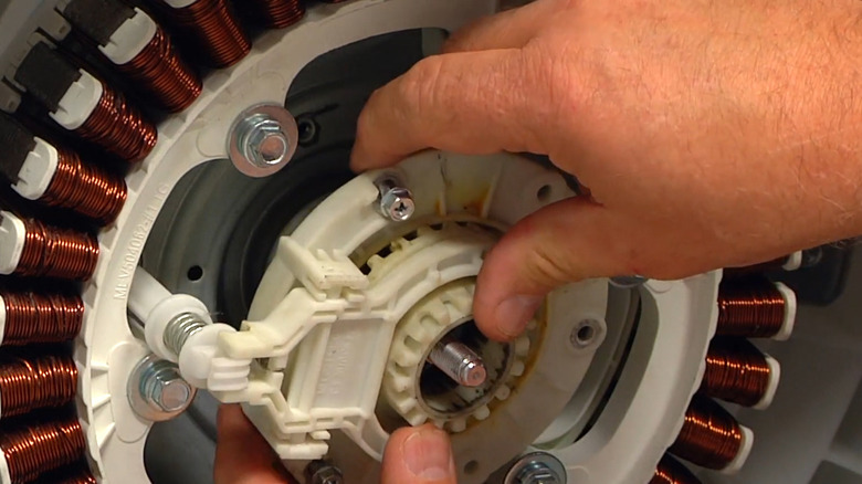 Removing a faulty motor coupling assembly from an LG washing machine