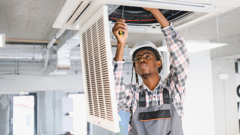 Young man repairing HVAC system