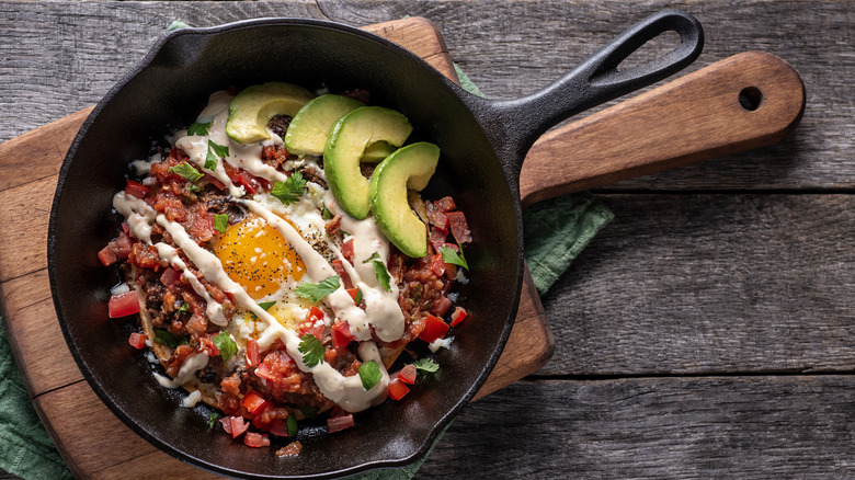Egg and vegetables cooking in a cast iron pan