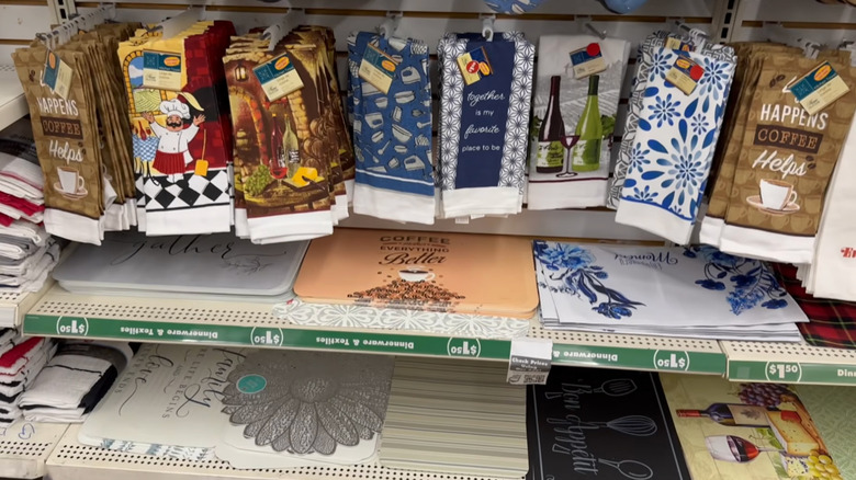 A row of decorative kitchen towels is displayed in the kitchen section at Dollar Tree