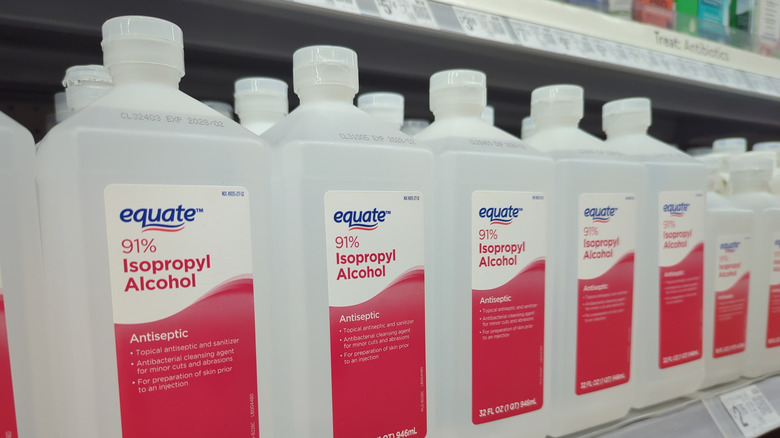 Bottles of rubbing alcohol sitting on a store shelf