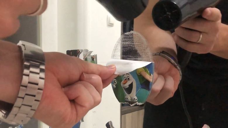 Removing stickers using a hair dryer