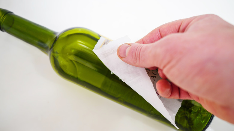 Removing a label from a wine bottle