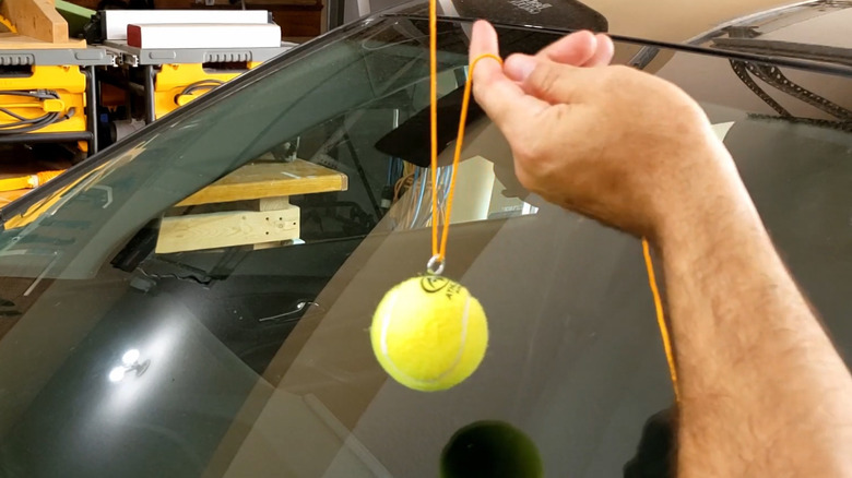 Measuring the correct height for a parking-stop tennis ball