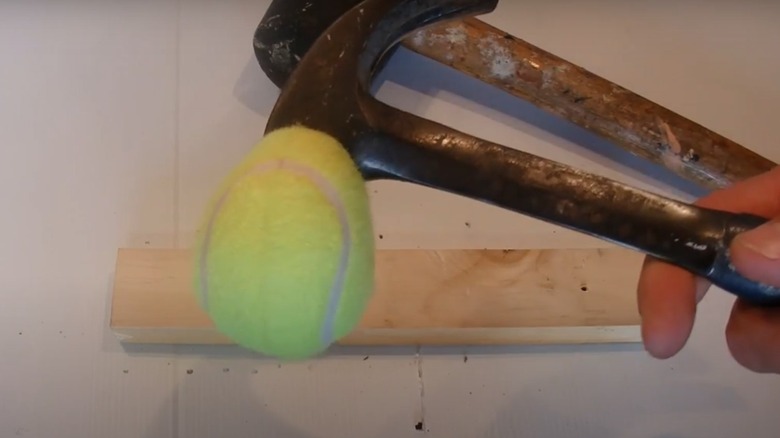 A hammer converted into a mallet with a tennis ball