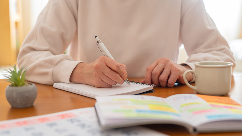 A person writing in a notebook