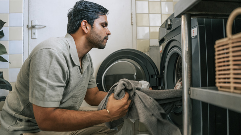 Man taking clothes out of the washing machine