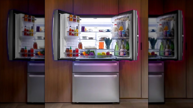 The doors of a GE Profile French door refrigerator are both opened to reveal fresh foods