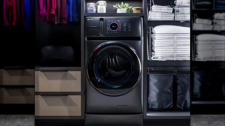 Folded laundry surrounds a charcoal GE UltraFast electric washer and dryer combo