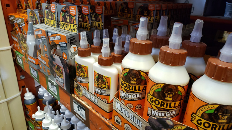 A variety of Gorilla Glue products sit on a hardware store shelf