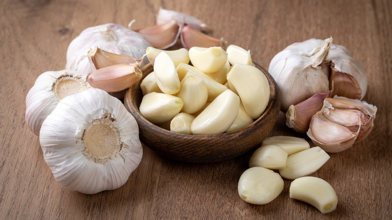 garlic bulbs and cloves in a small wood bowl