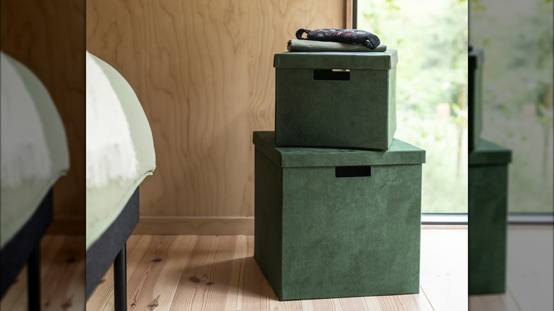 Stack of two IKEA GJÄTTA storage boxes with lids in dark green velvet