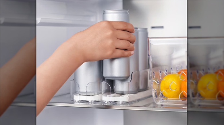person grabbing drink from IKEA KLIPPKAKTUS Drink holder in fridge