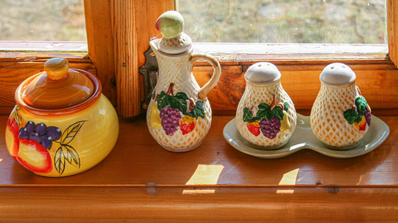 Country style ceramic dishware on windowstill