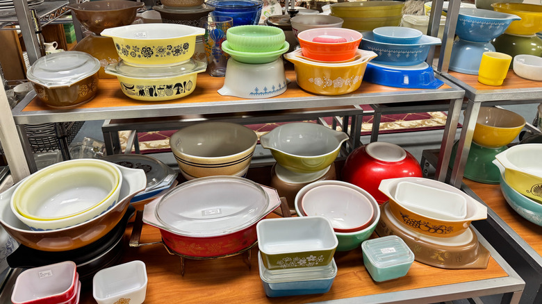 Many colors of vintage Pyrex on display in a shop
