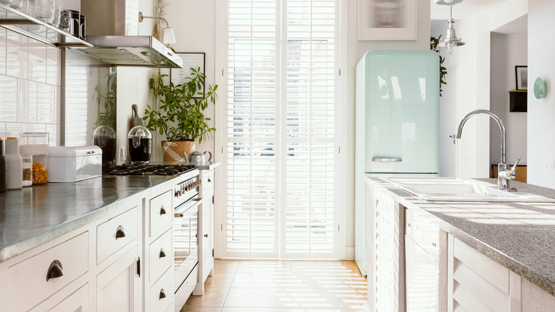 A kitchen with a pastel fridge