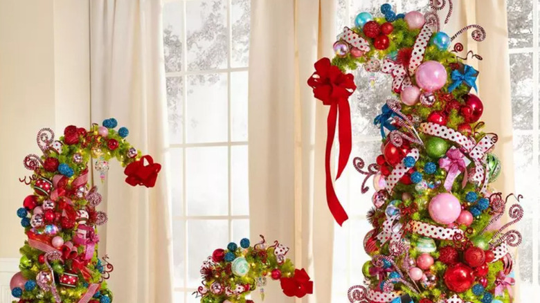 Three decorated Christmas trees with curved tops