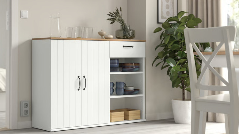 White sideboard used for kitchen storage
