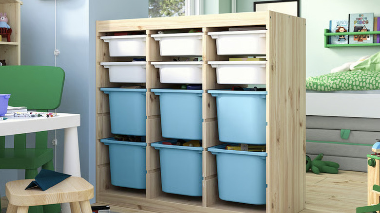 IKEA wooden dresser with colorful storage bins in a child's playroom