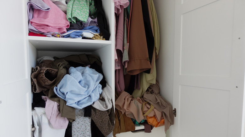A cluttered clothes closet