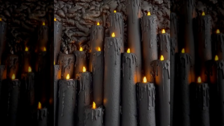 Several black candle decorations made of pool noodles are clustered together