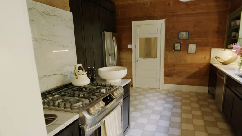 A kitchen accent wall is covered in raw shiplap