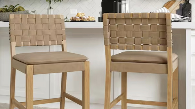 Simple light brown bar stools next to a kitchen counter