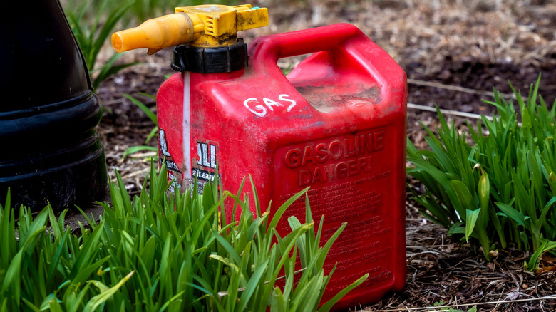 Gas can sitting outside on a lawn.