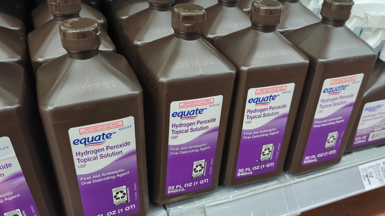 Brown bottles of hydrogen peroxide on a store shelf